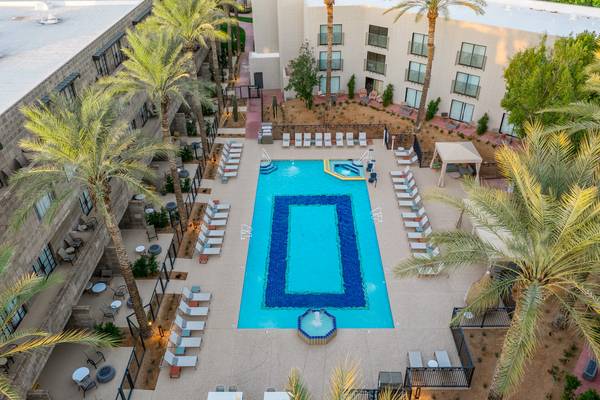 Aerial view of a resort courtyard pool with palm trees